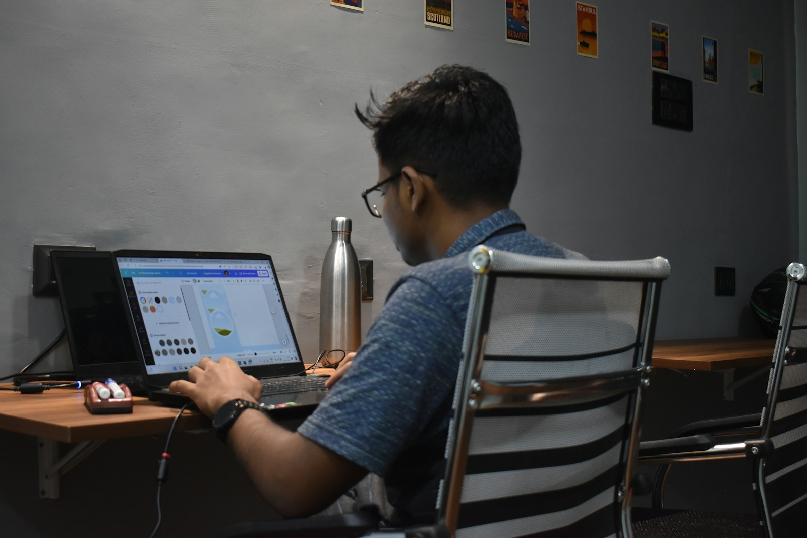 A man sitting in front of a laptop computer